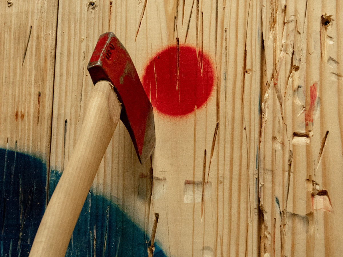 image of an axe in wooden target